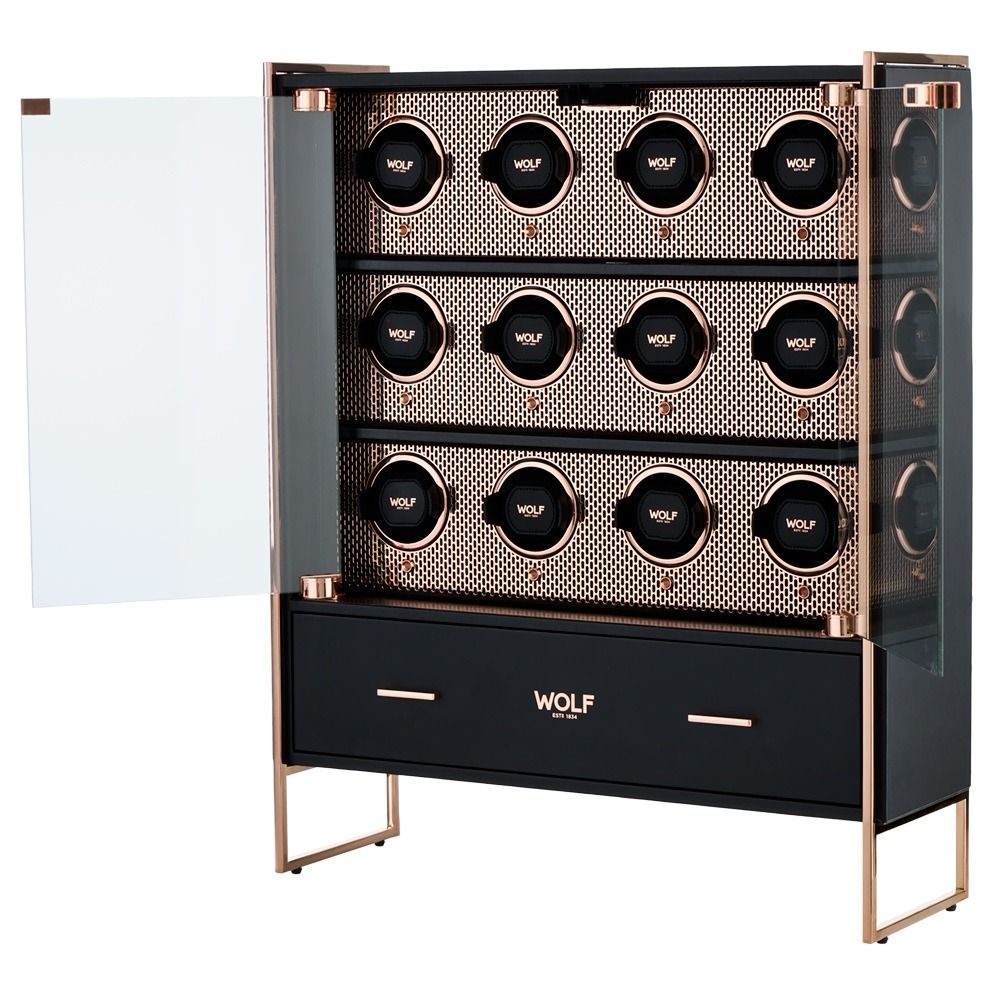 Gold-framed glass-front watch cabinet with four rows of watch slots and a black drawer labeled WOLF.