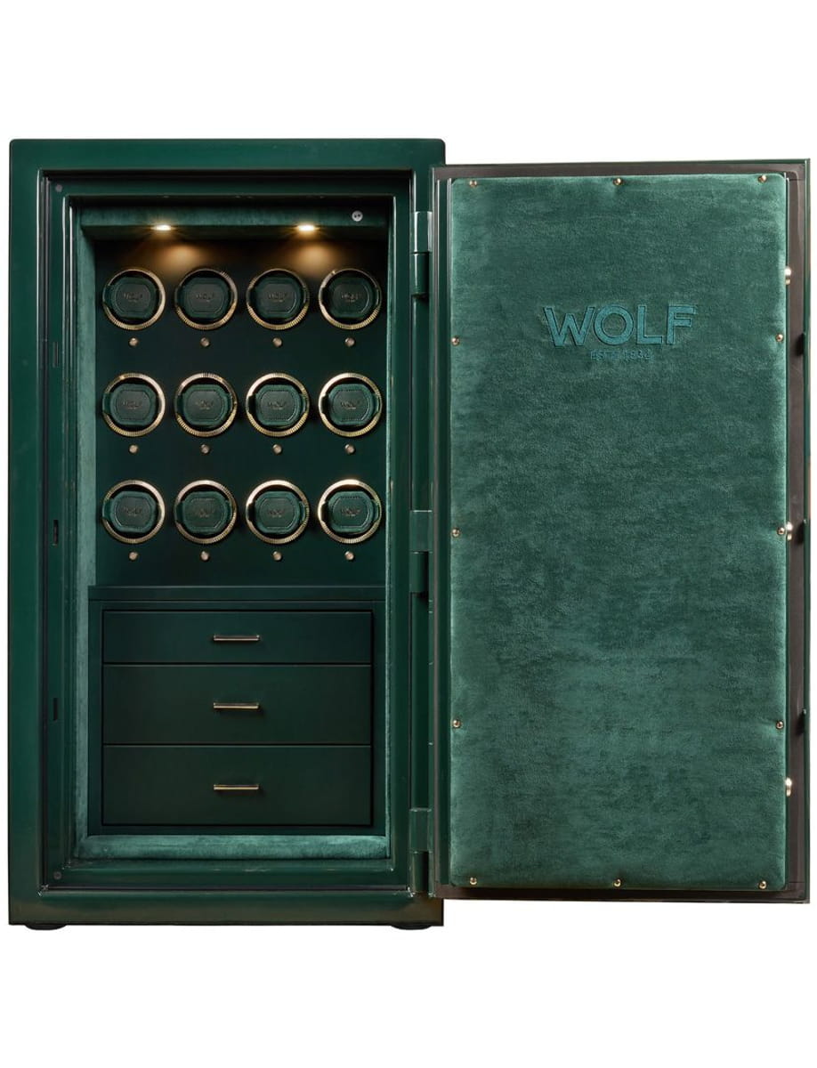 Open green Wolf safe showing twelve circular locking compartments and three drawers below.