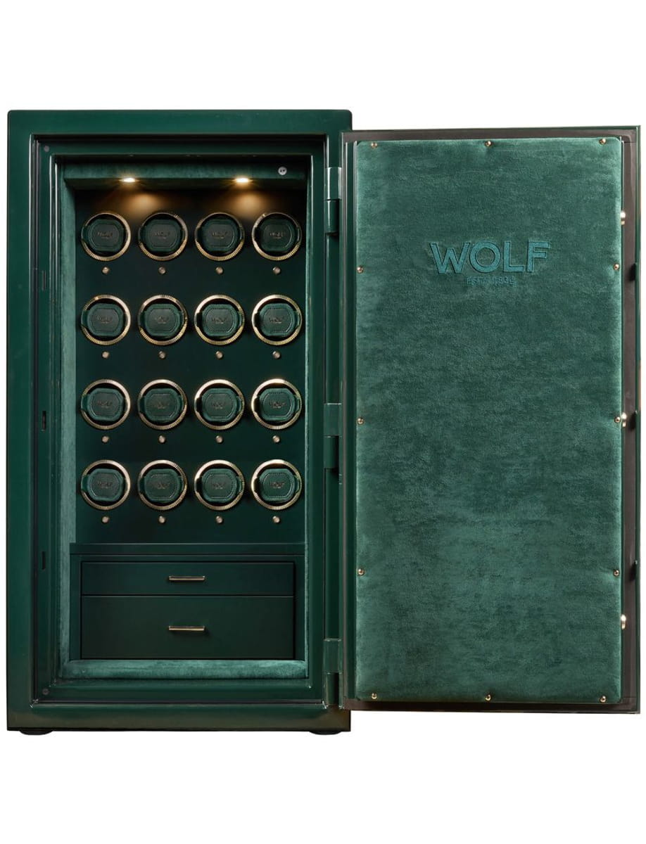 Open green Wolf safe with 18 circular watch winders and two drawers, displaying organized storage for watches.