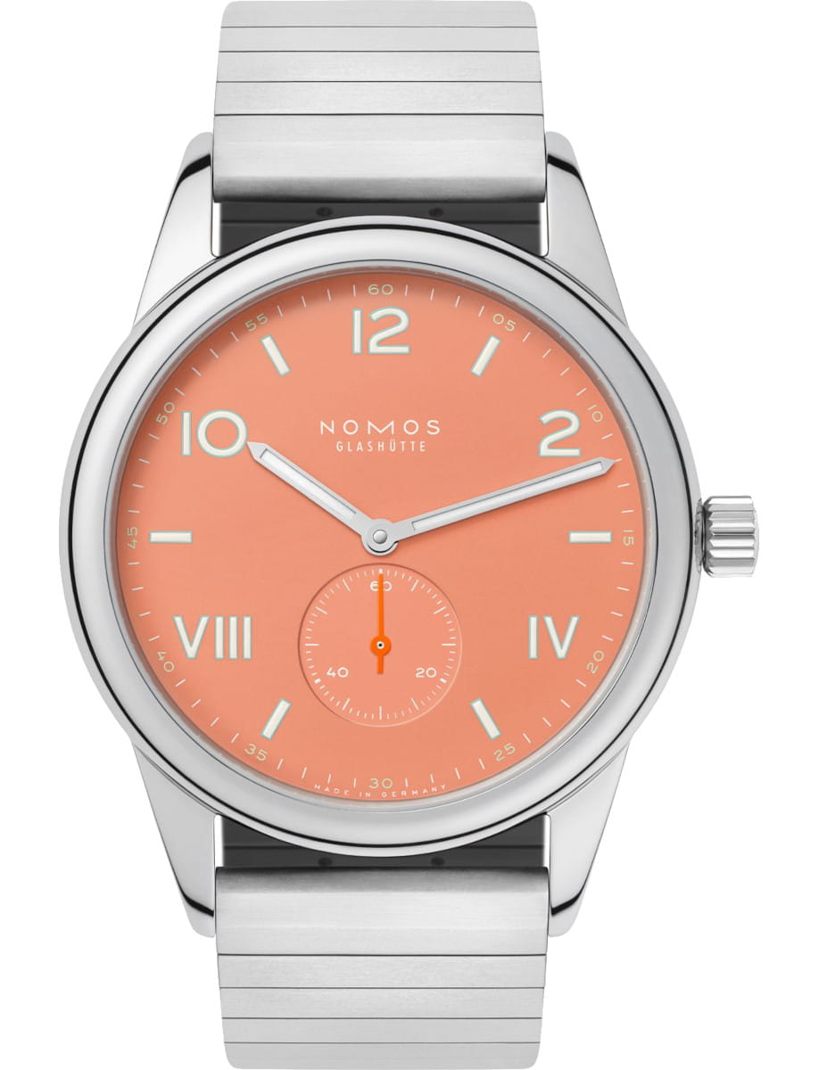 Stainless steel wristwatch with an orange dial, white numerals, and a small seconds subdial at 6 o'clock, branding NOMOS Glashütte, metal link bracelet