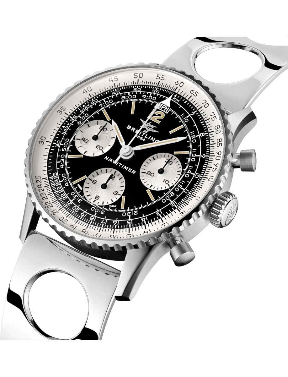 Close-up of a silver Breitling Navitimer chronograph with a black dial and multiple subdials on a metal bracelet.