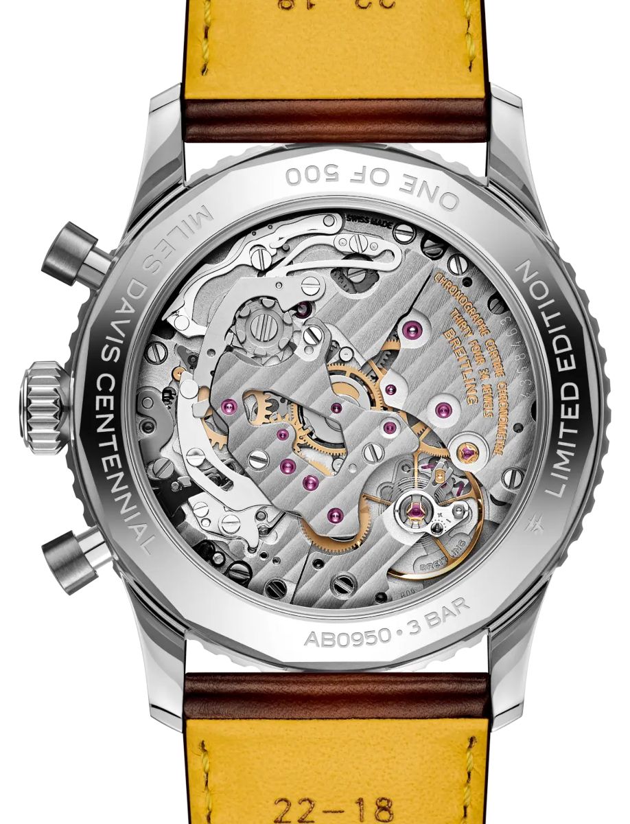 Limited edition chronograph watch: view of the intricate mechanical movement through a transparent case back, with silver gears and ruby jewels, paired with a brown leather strap.