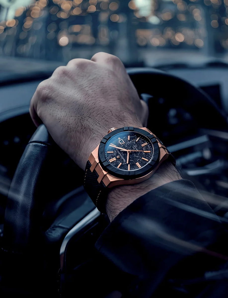 Close-up of a Maurice Lacroix automatic wristwatch with a bronze case, bi-rubber strap with imitation nylon-textured rubber, and frozen carbon dial.