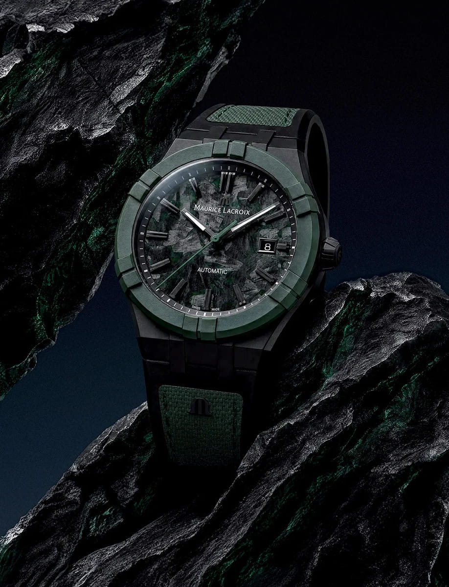 Maurice Lacroix automatic wristwatch with a titanium case, green strap, and a date window at 3 o'clock.