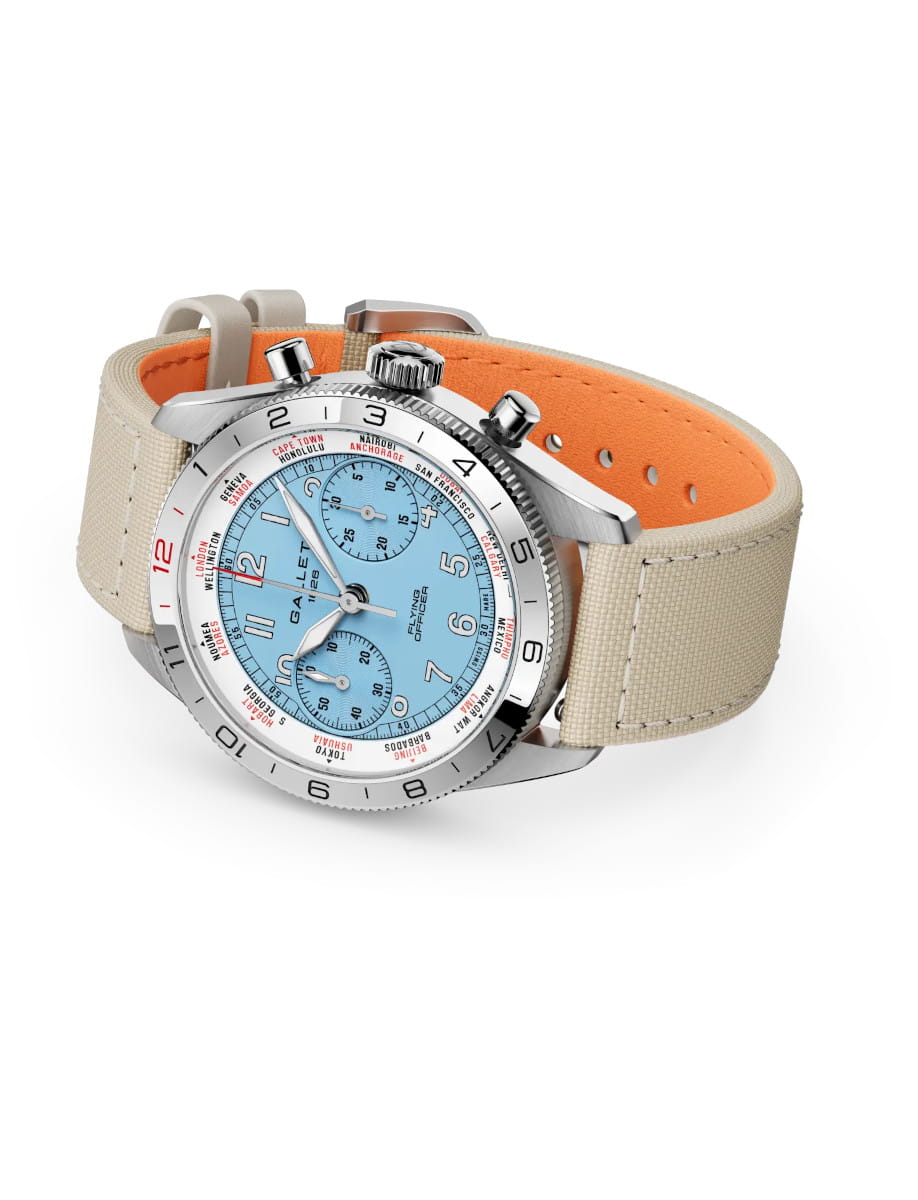 Beige fabric-strap chronograph watch with a light blue dial and steel case.