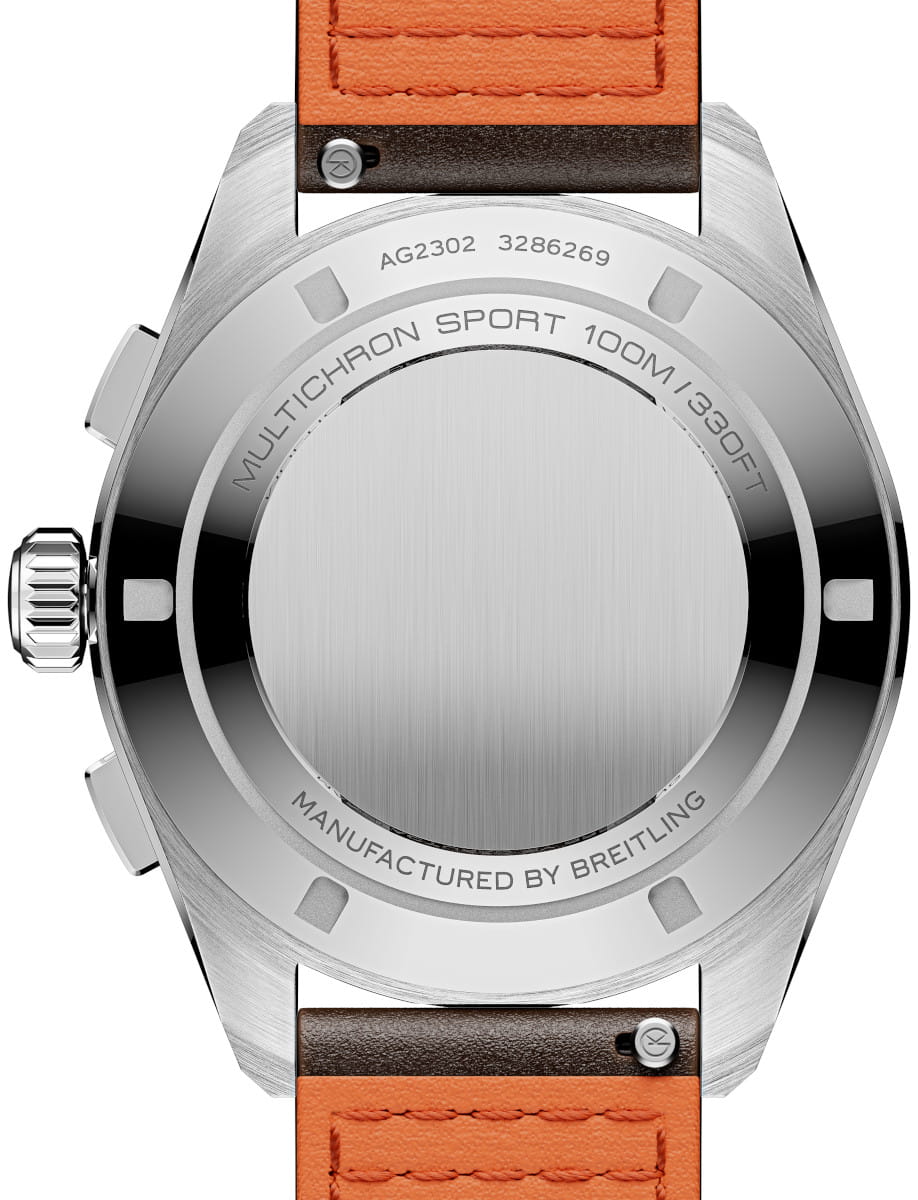 Back of a stainless Breitling watch with a brushed center, engraved with MULTICHRON SPORT 100M/330FT and MANUFACTURED BY BREITLING, attached to an orange leather strap