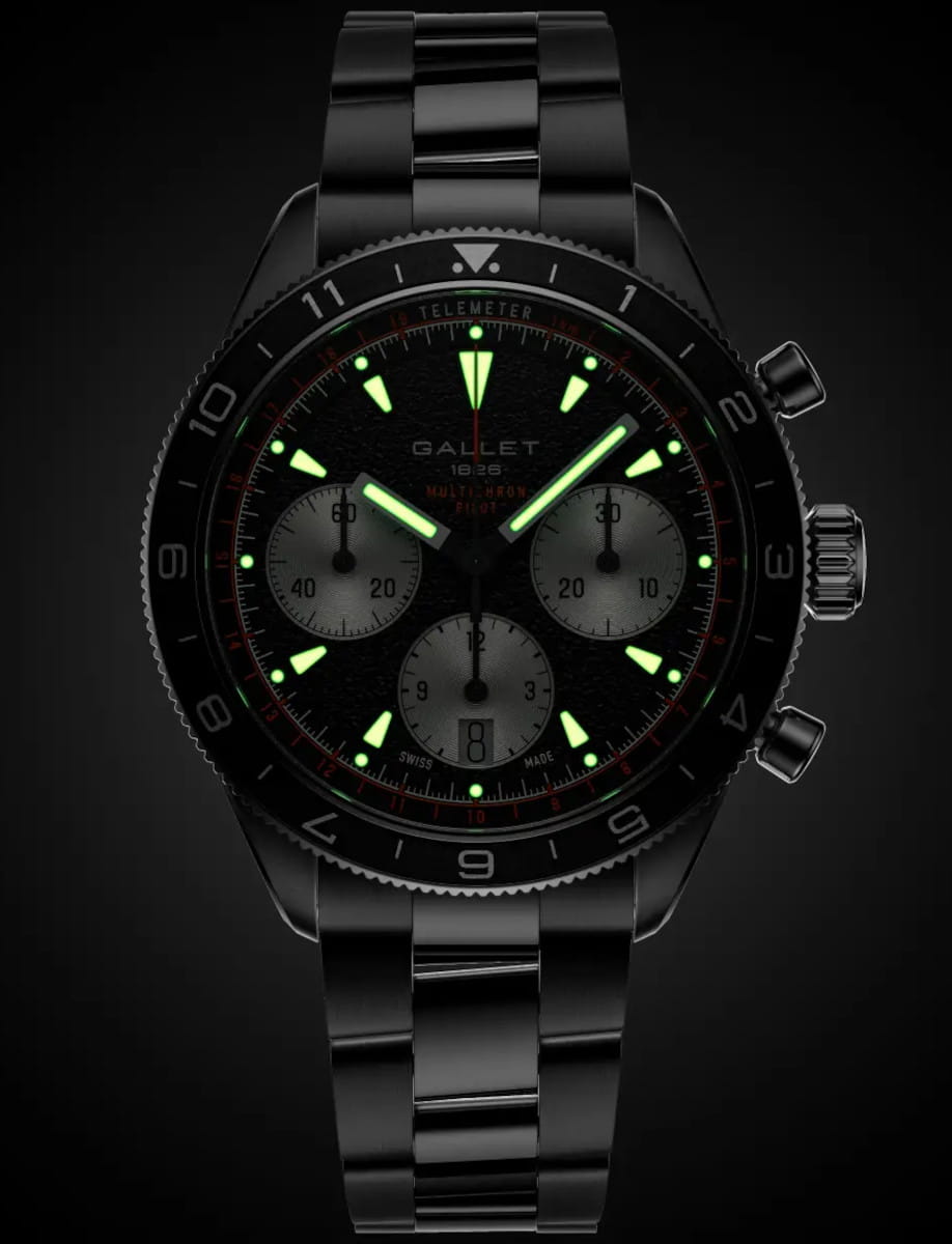 Gallet stainless steel chronograph wristwatch with luminescent green hands and markers on a dark background