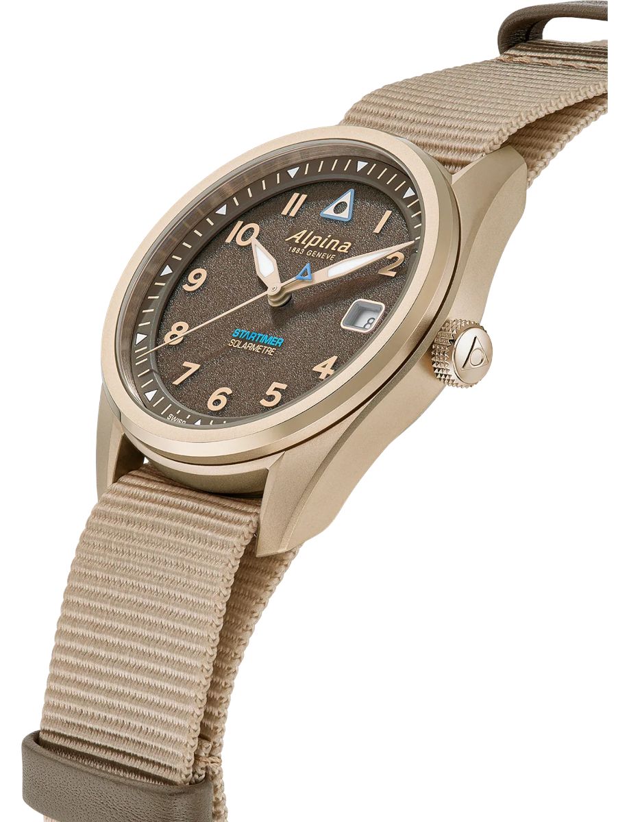 Beige Alpina Startimer watch with textured brown dial and beige NATO strap in a angled product shot.