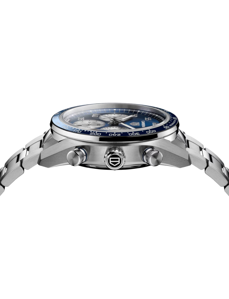Side view of a stainless steel chronograph wristwatch with a blue bezel and metal bracelet