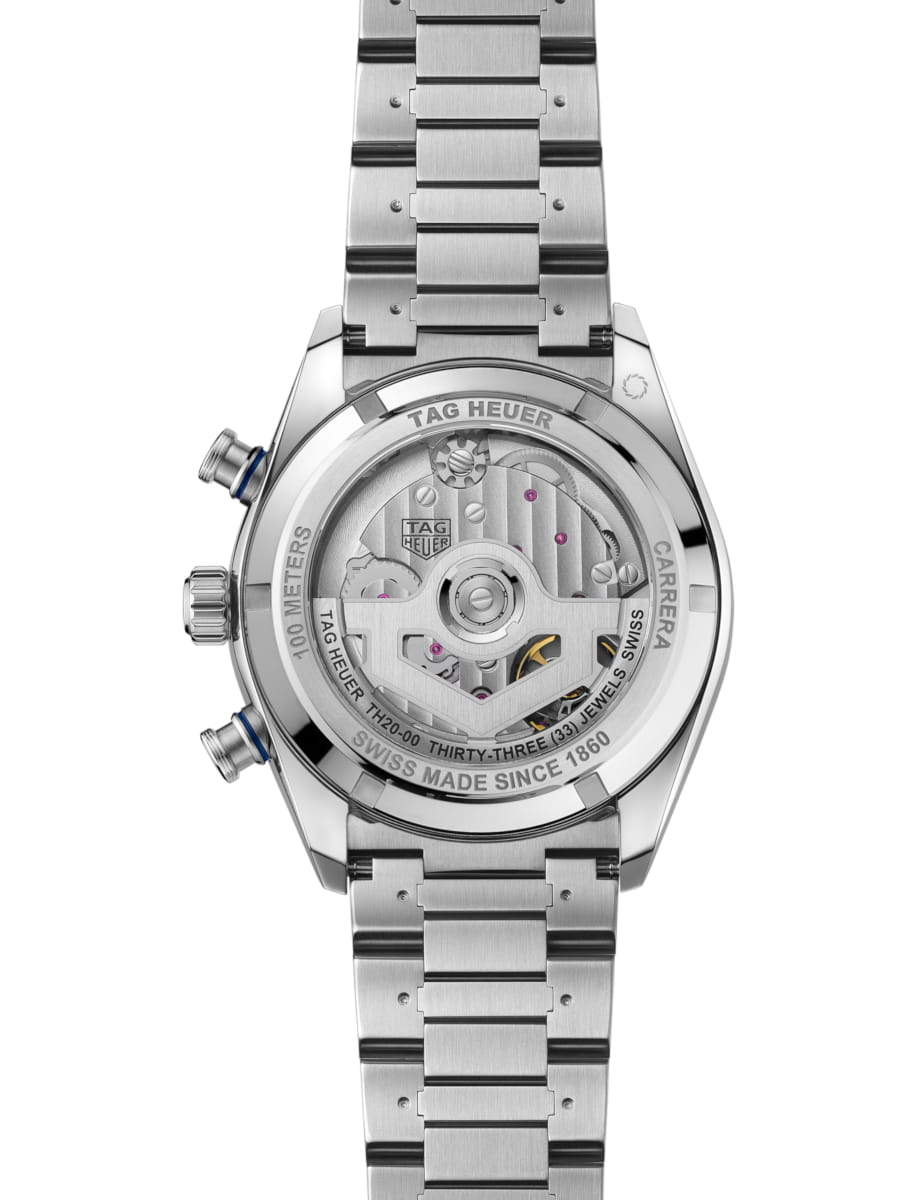 Back view of a stainless steel TAG Heuer Carrera watch, transparent caseback revealing the movement, rotor and gears; engraved 'Swiss Made Since 1860' and '100 Meters'.