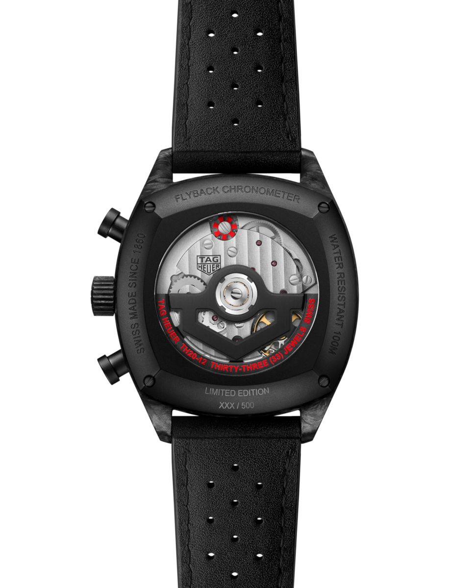 Back view of a TAG Heuer Flyback Chronometer watch with visible rotor and gears, perforated black leather strap, limited edition XXX/500.
