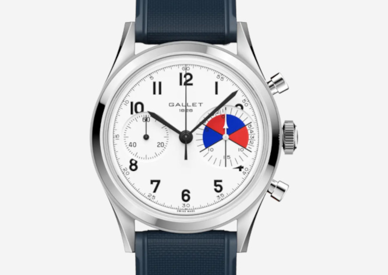 Chronograph wristwatch with a white dial, black numerals, silver case, and blue strap; right subdial shows colored red/blue segments.