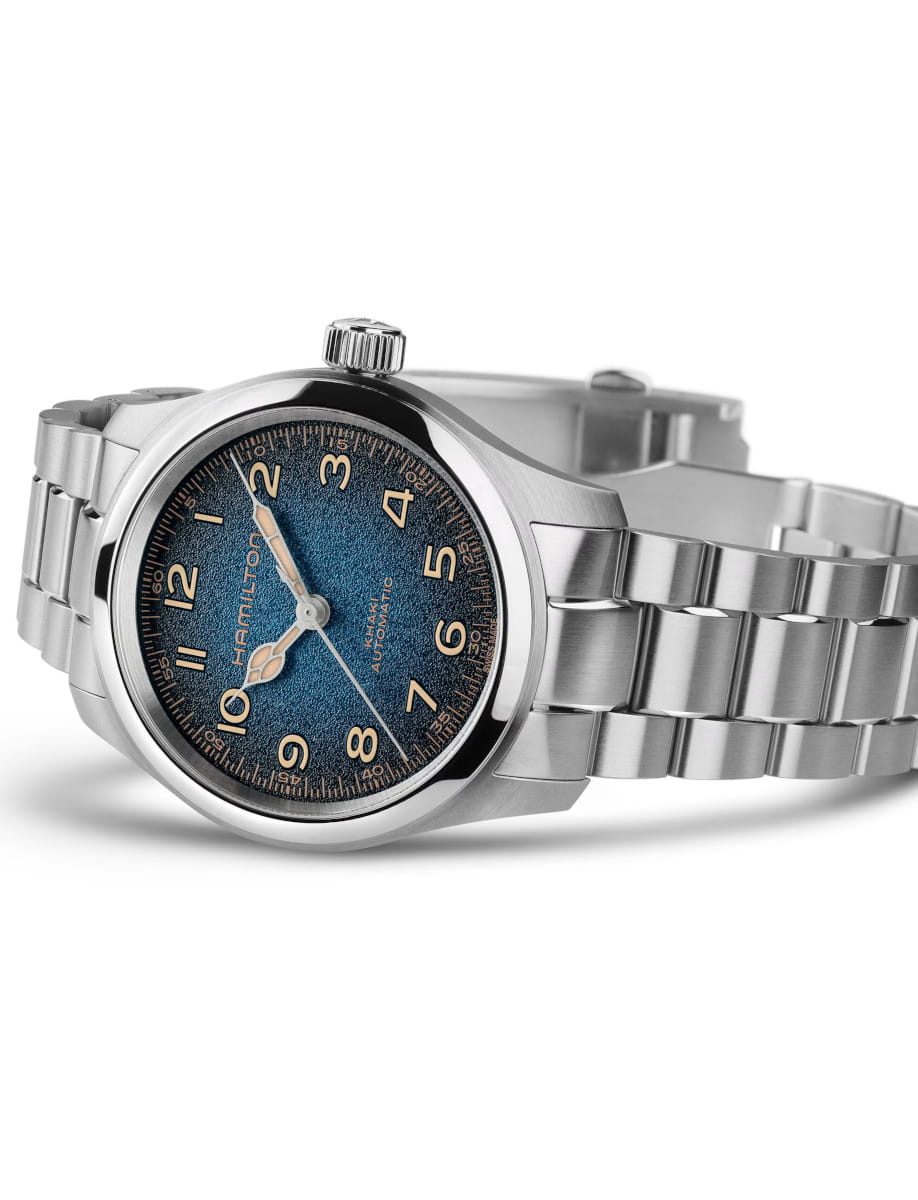 Stainless steel Hamilton automatic wristwatch with a blue textured dial and luminous Arabic numerals.