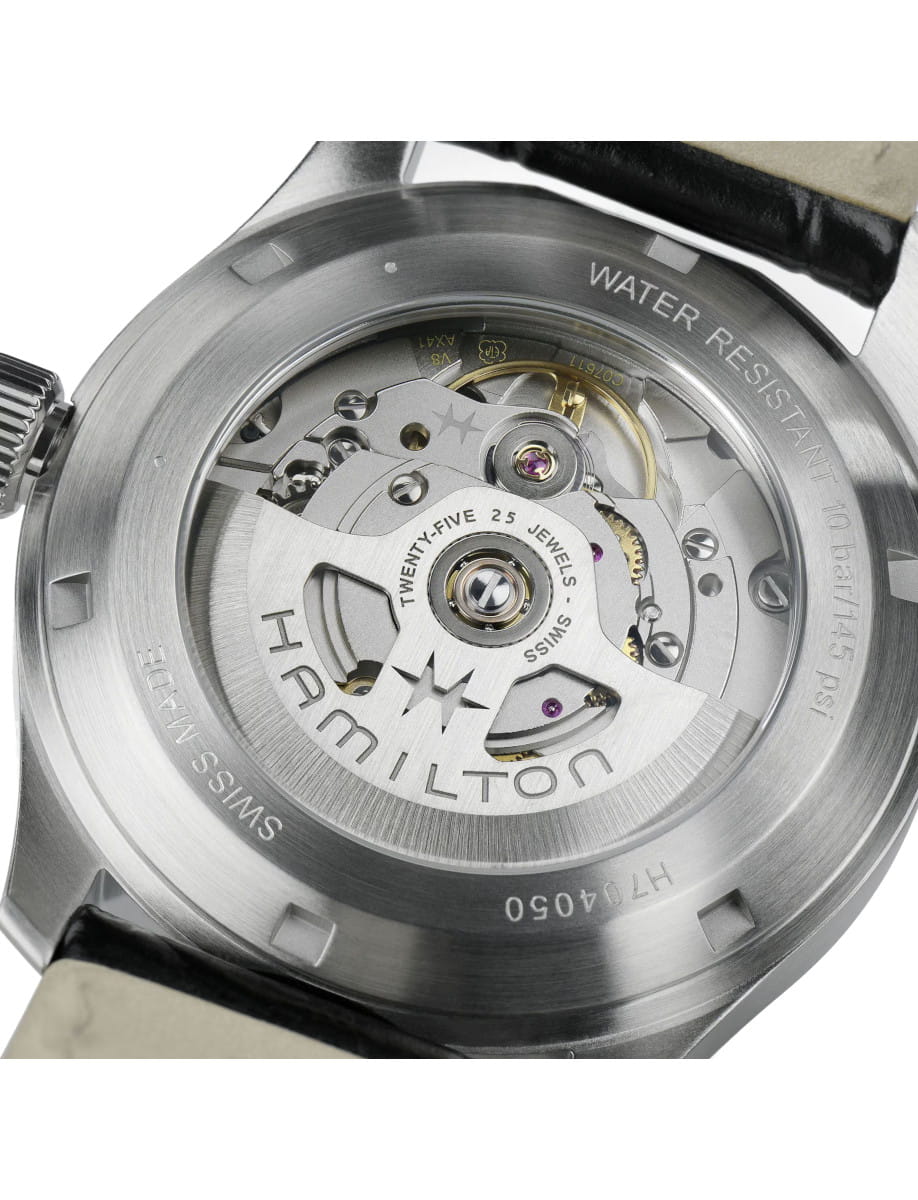 Close-up of the back of a Hamilton automatic watch, showing the intricate movement with visible gears, jewels, and the engraved rotor reading 'HAMILTON' and 'TWENTY-FIVE 25 JEWELS'.