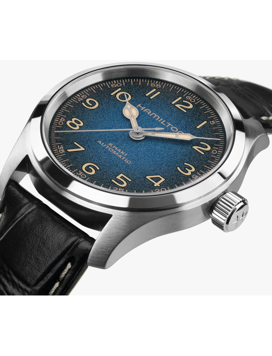 Close-up of a Hamilton automatic wristwatch with a blue textured dial, stainless steel case, and black leather strap.