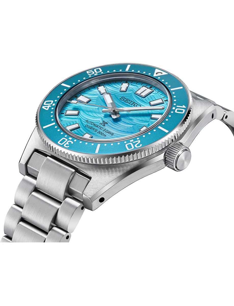 Stainless steel Seiko diver's watch with a turquoise blue dial, blue rotating bezel, and brushed metal bracelet, 300m water resistance