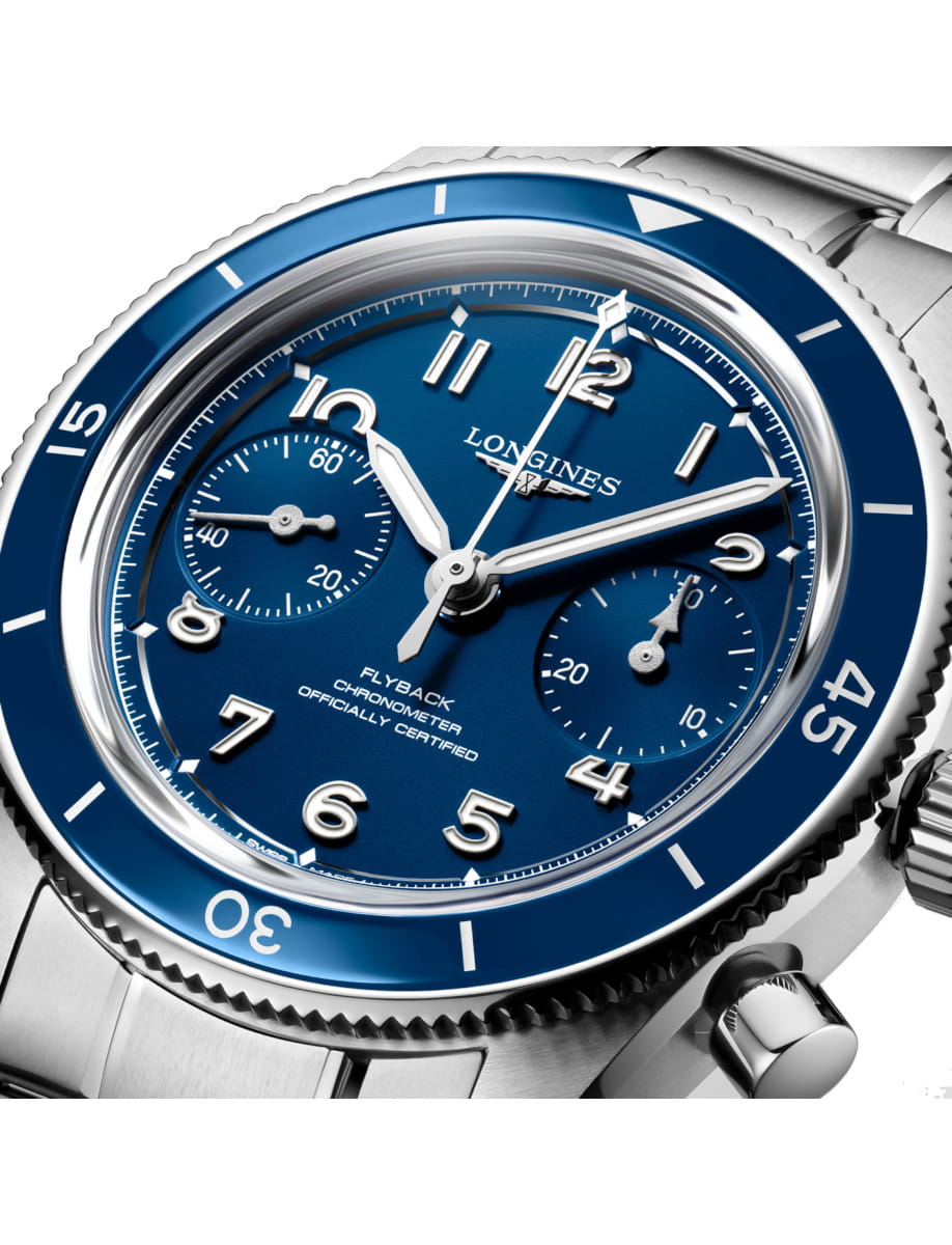 Close-up of a Longines wristwatch with stainless steel case and bracelet, ceramic bezel and blue dial.