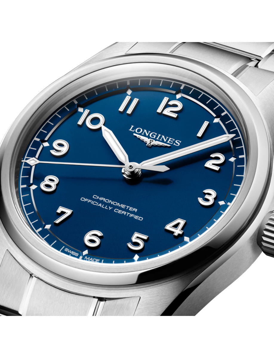 Close up of Longines wristwatch with stainless steel case and bracelet, and blue dial.