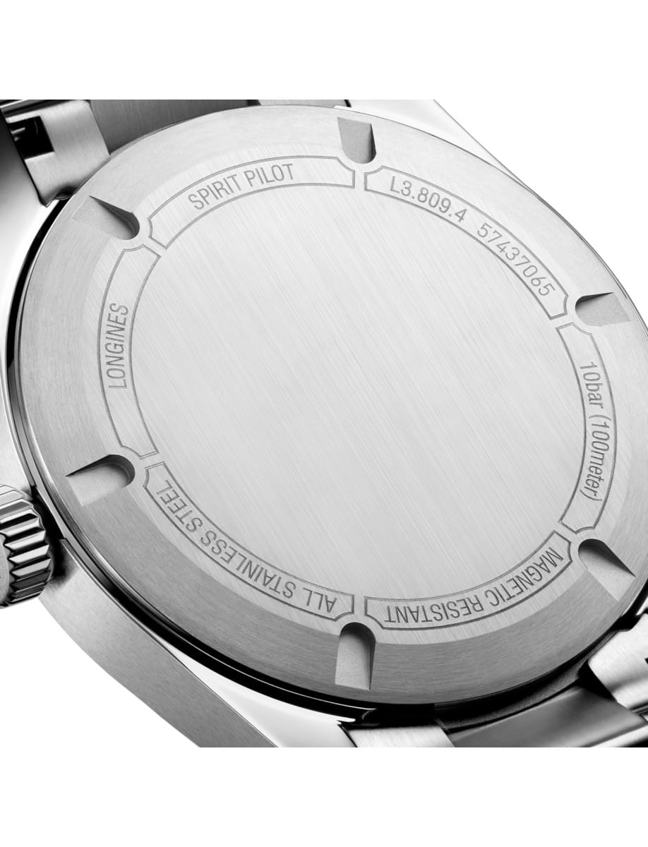 Close-up of a stainless steel watch case back with engraved text: Spirit Pilot, Longines, water resistance 100m, all stainless steel, magnetic resistance