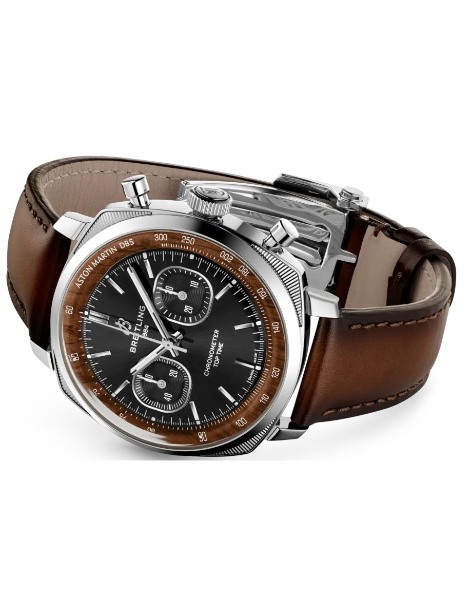 Breitling chronograph watch with black dial, brown bezel, steel case, and brown leather strap viewed at an angle.