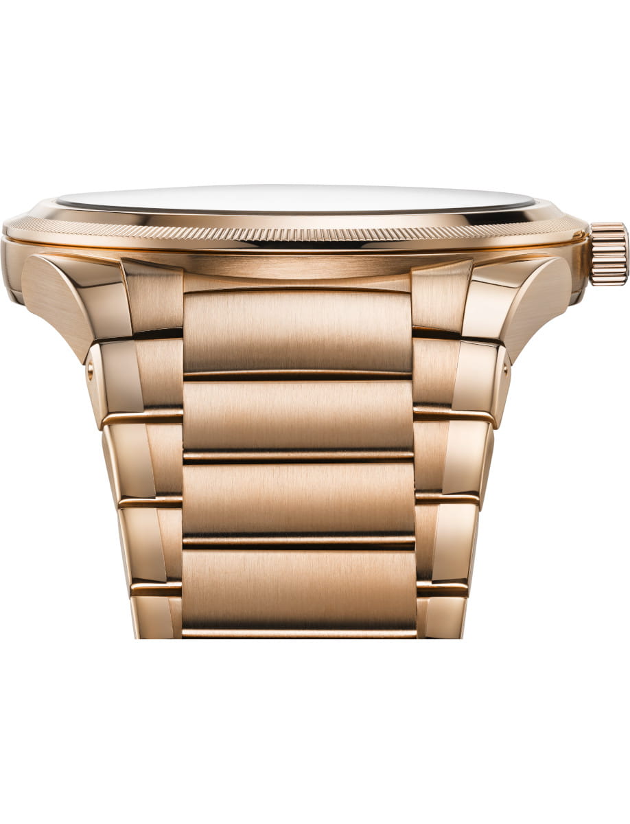 Close-up of a gold-tone wristwatch with brushed link bracelet viewed from the side, showing the case edge and crown on the right.