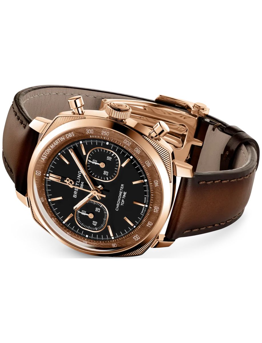 Rose-gold Breitling chronograph watch with a black dial and brown leather strap on a white background