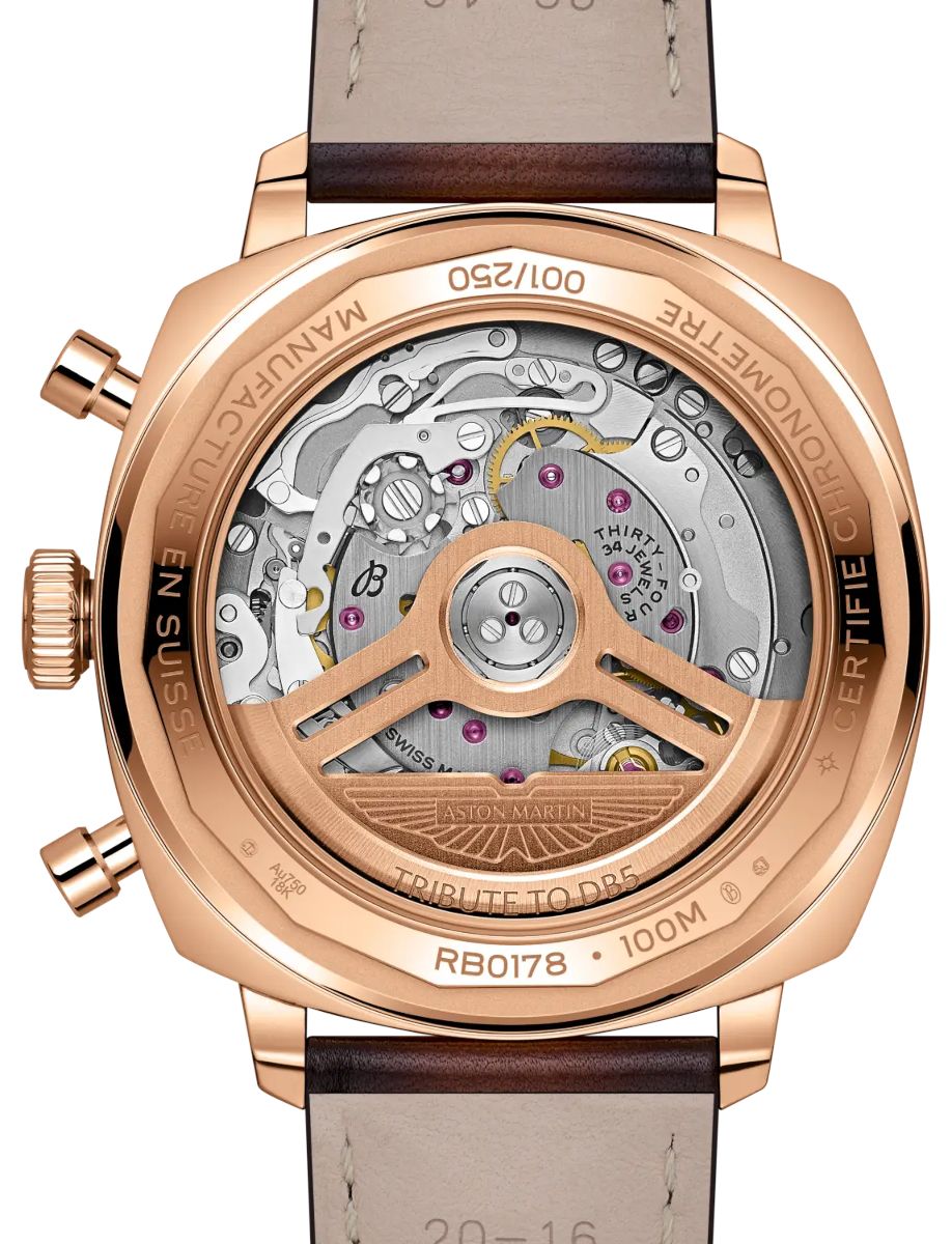 Rose-gold wristwatch with a transparent case back, exposing the intricate automatic movement, rotor and gears, with engravings like 'Tribute to DB5' and 'Aston Martin' on the rotor and bezel.