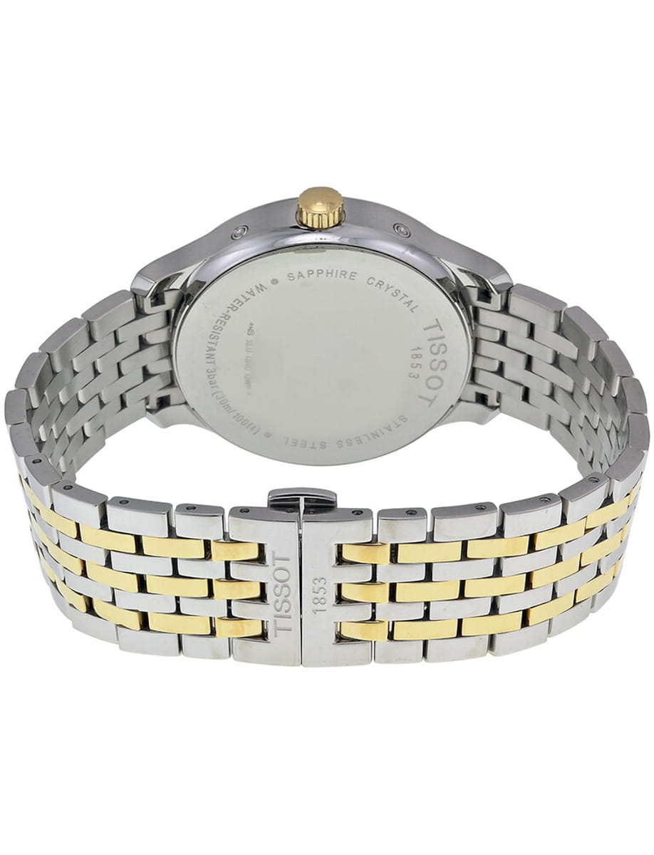 Two-tone stainless steel watch with gold center links, shown from the back with a fold-over clasp engraved 'TISSOT 1853'