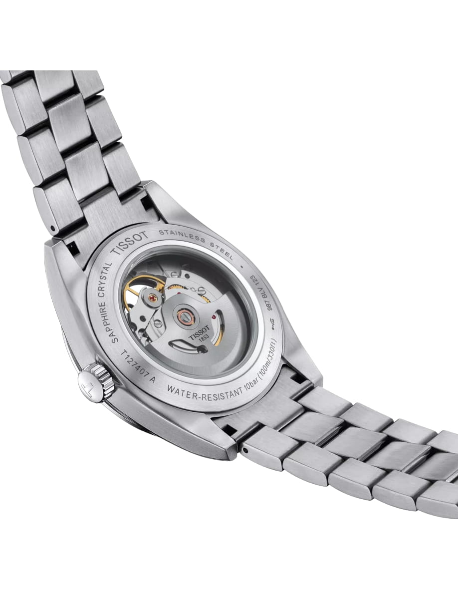 Stainless steel wristwatch with a transparent case back showing the mechanical movement and rotor.