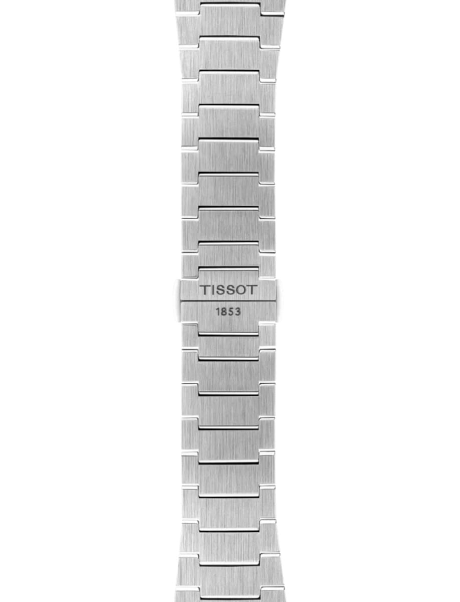 Close-up of a silver stainless steel watch bracelet with a brushed finish and a TISSOT 1853 clasp.