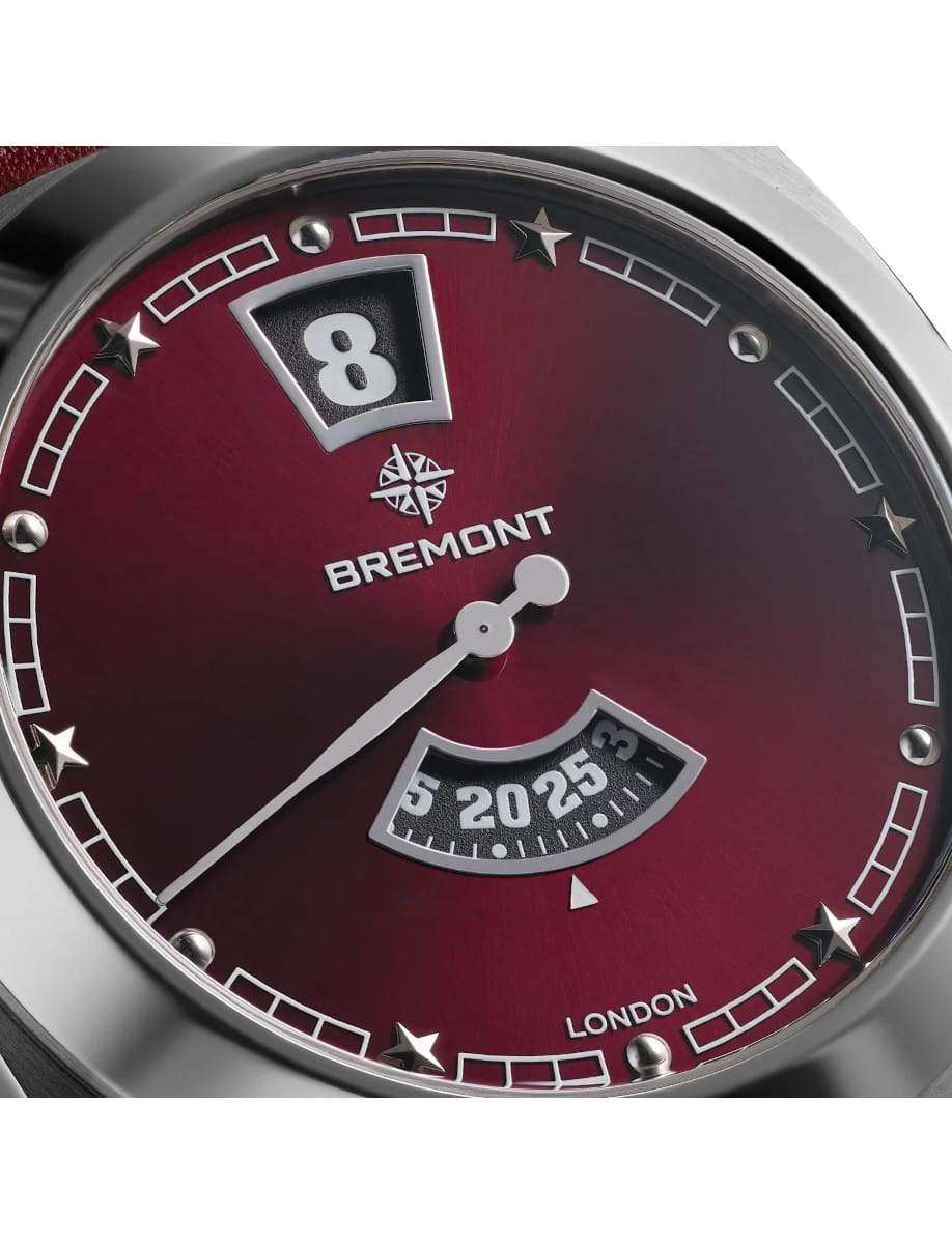 Close-up of a Bremont Terra Nova watch face with a burgundy dial, white markers, and a date window showing 8.