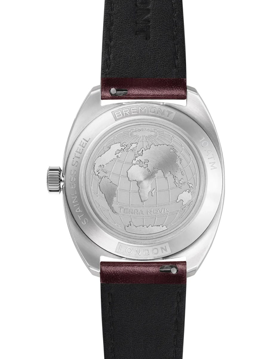 Back of a stainless steel Bremont watch, engraved globe map with 'TERRA NOVA' and 'LONDON' inscriptions, leather strap with burgundy accents.
