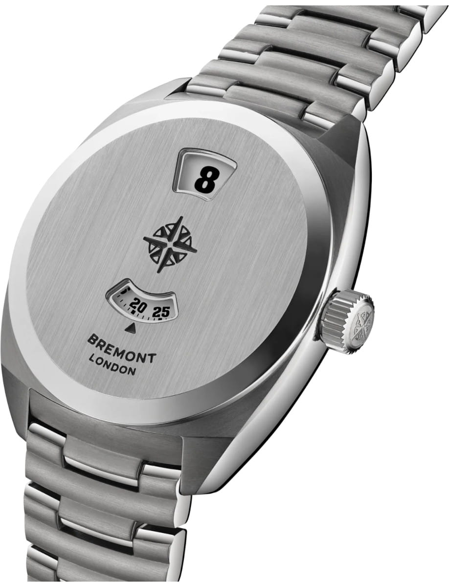 Side view of Close-up of a brushed steel Bremont watch case showing hour and minute windows.
