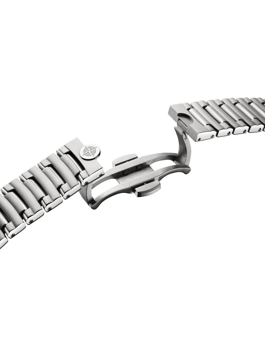 Close-up of a stainless steel watch band with a deployed butterfly clasp spread open.