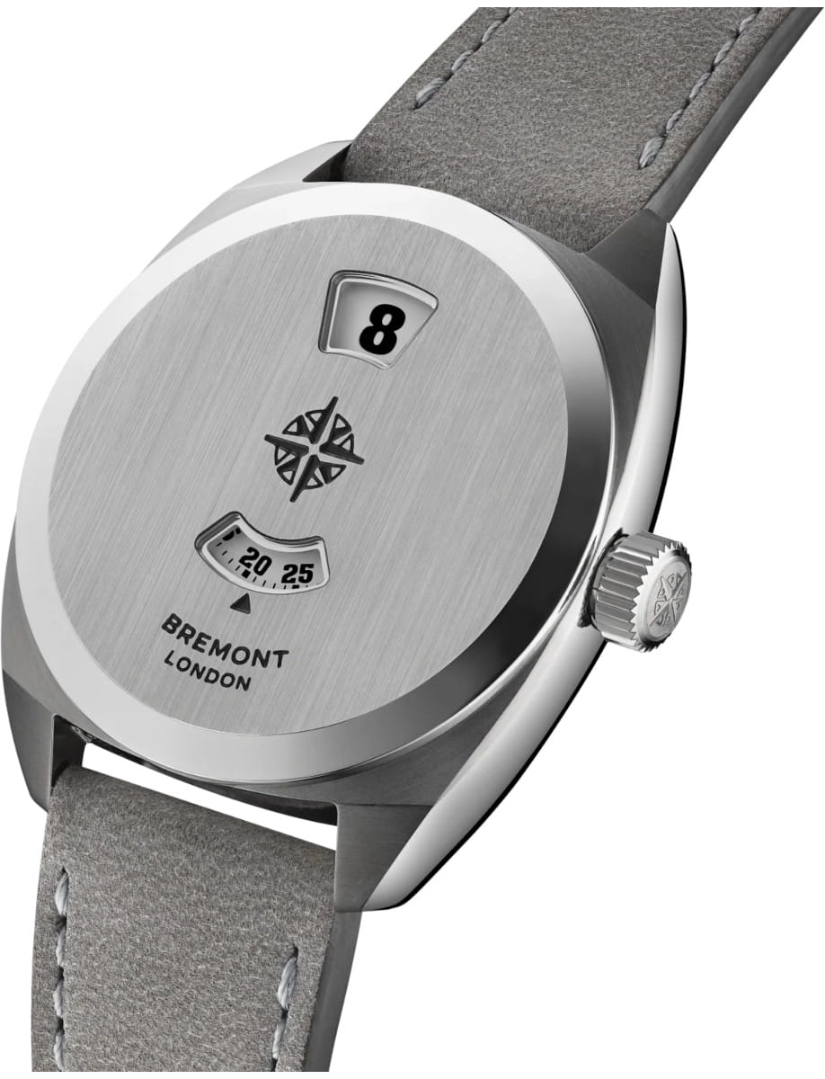 Side view of a Bremont wristwatch with brushed stainless steel case, crown, and grey leather strap edge visible.
