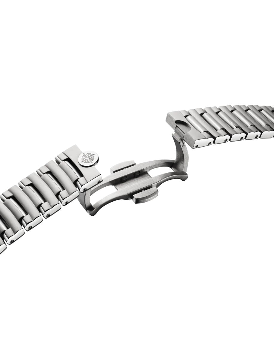 Close-up of a stainless steel watch band with a deployed butterfly clasp spread open.