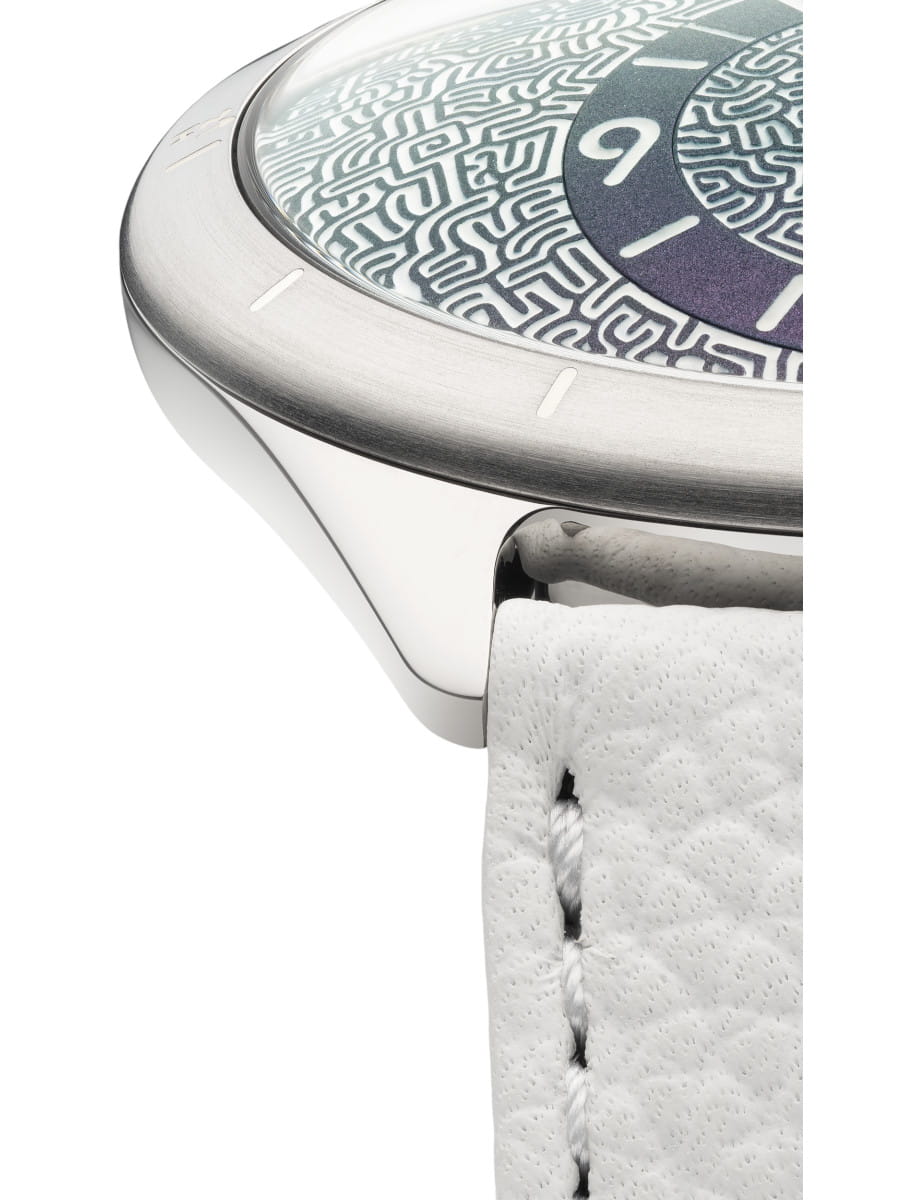 Close-up of a Ressence wristwatch with Grade 5 Titanium case, Emerald green dial, and white calf leather strap.