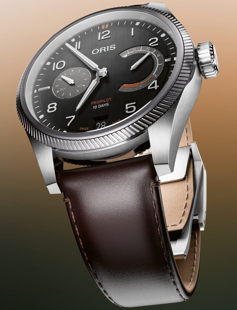 Oris Pilot watch with black dial, large white numerals, power-reserve and small seconds subdials, stainless steel case, dark brown cordovan leather strap.