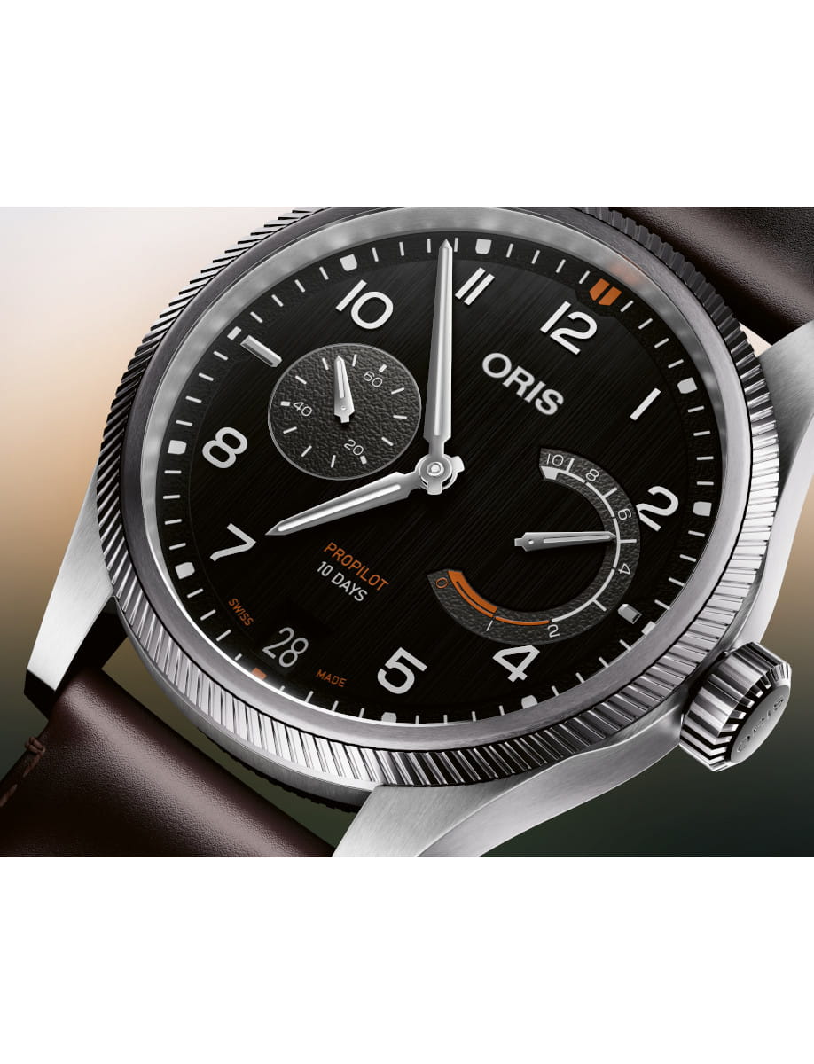 Close-up of an Oris ProPilot 10 Days wristwatch with a black dial, bold white numerals, subdial, power-reserve indicator, and dark brown cordovan leather strap.