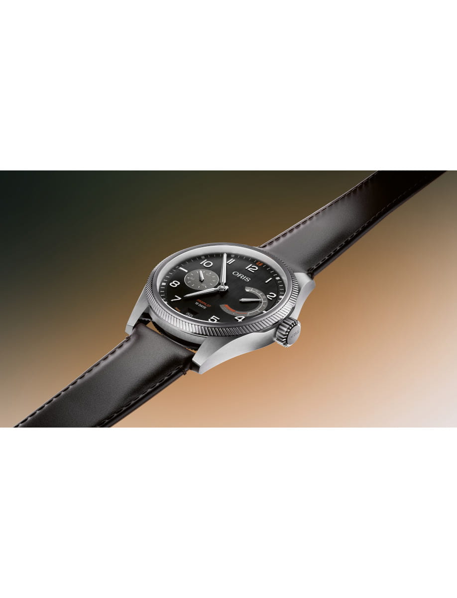 Oris ProPilot watch with stainless steel case, black dial, white numerals, two subdials, date window, and dark brown cordovan leather strap, shown at an angled perspective
