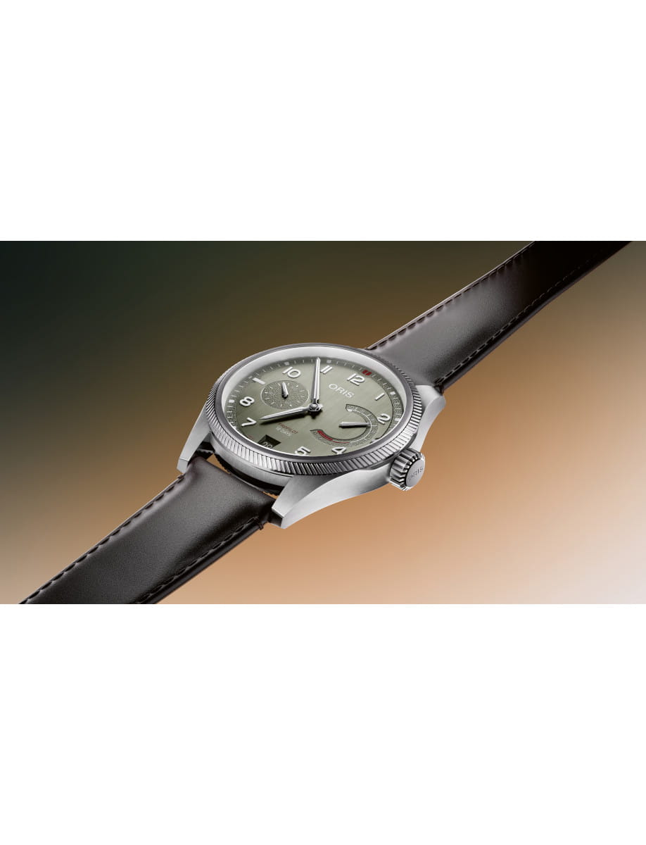 Oris wristwatch with a green dial, stainless steel case, and black leather strap.
