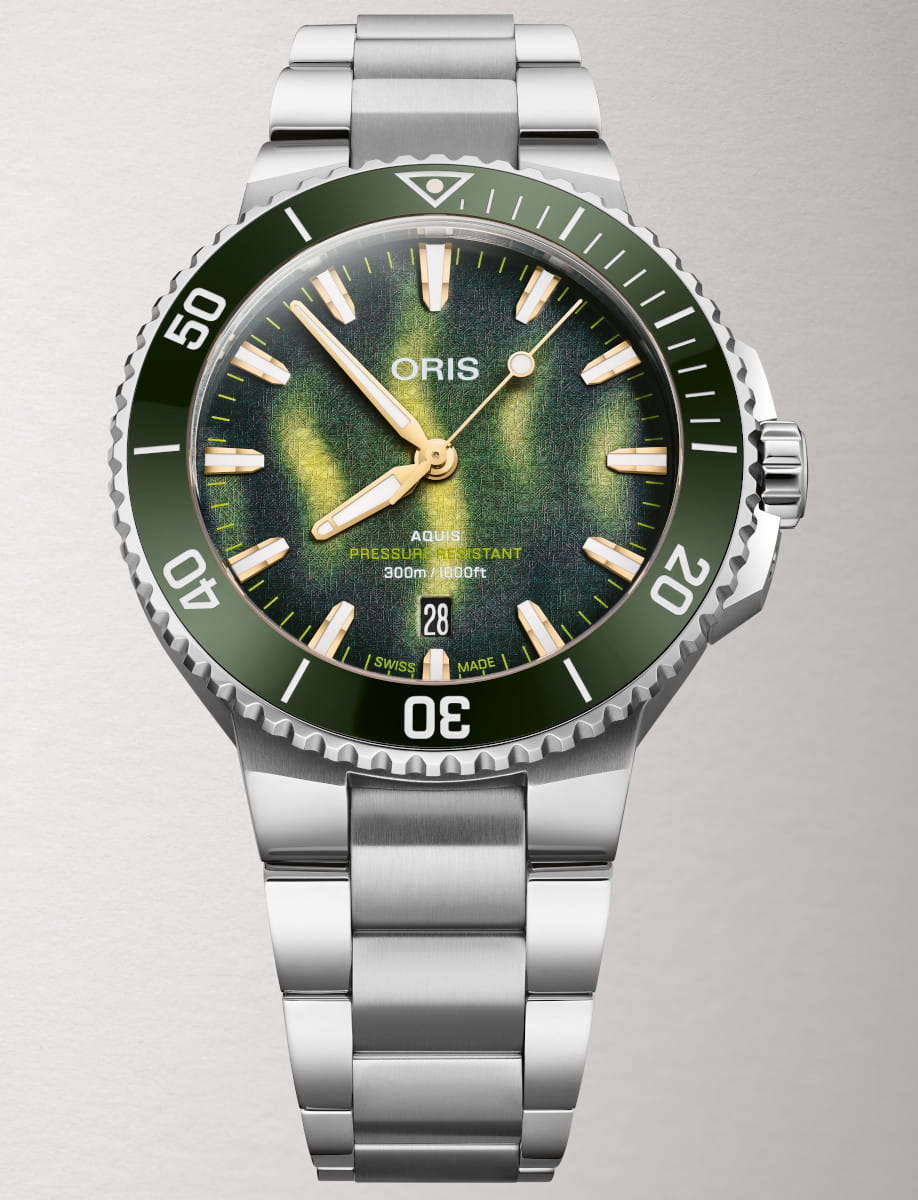 Stainless steel Oris Aquis dive watch with green textured dial and bold gold indices; date window at 6 o'clock; rotating bezel