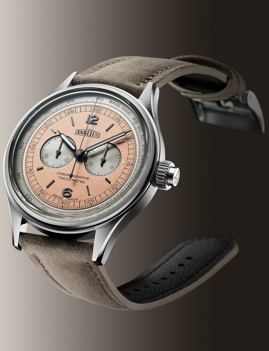 Side view of Angélus chronograph watch with stainless steel case, coral-pink dial, tachymeter scale, and sepia grey leather strap.