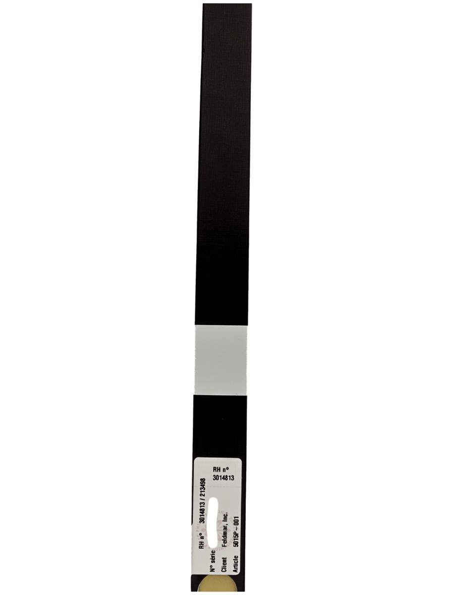 Vertical test strip with black sections and a light gray band in the middle, a label with small printed numbers at the bottom.