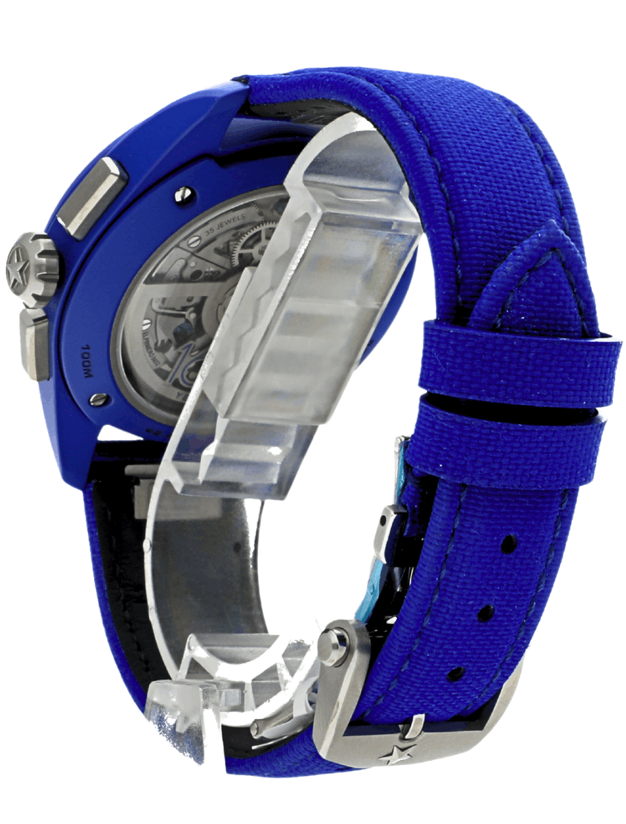Back view of pre-owned Zenith Pilot chronograph wristwatch with a blue fabric strap, blue ceramic case, and a transparent back showing its mechanical movement.