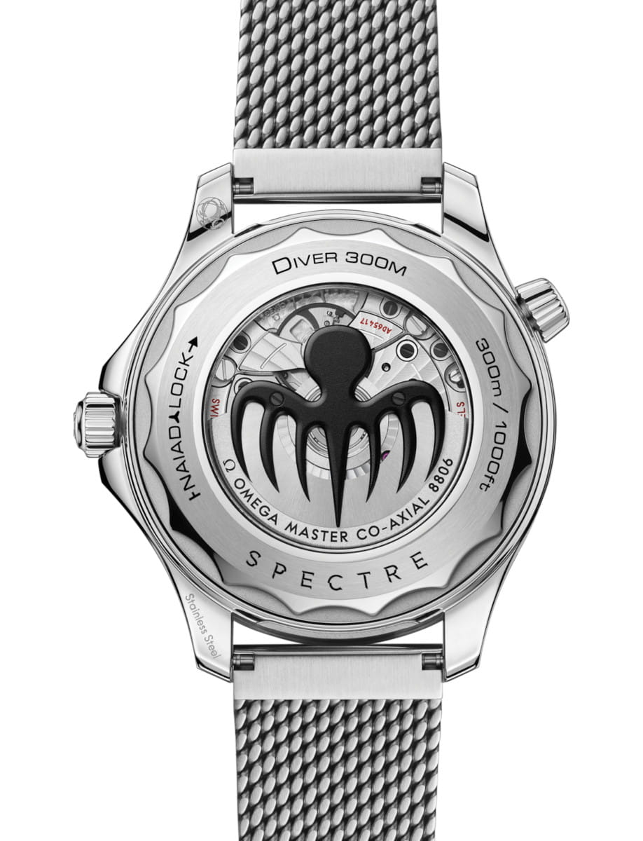 Stainless steel Omega Seamaster case back with a black Spectre spider emblem, mesh bracelet, and engraved text including Spectre and Diver 300m
