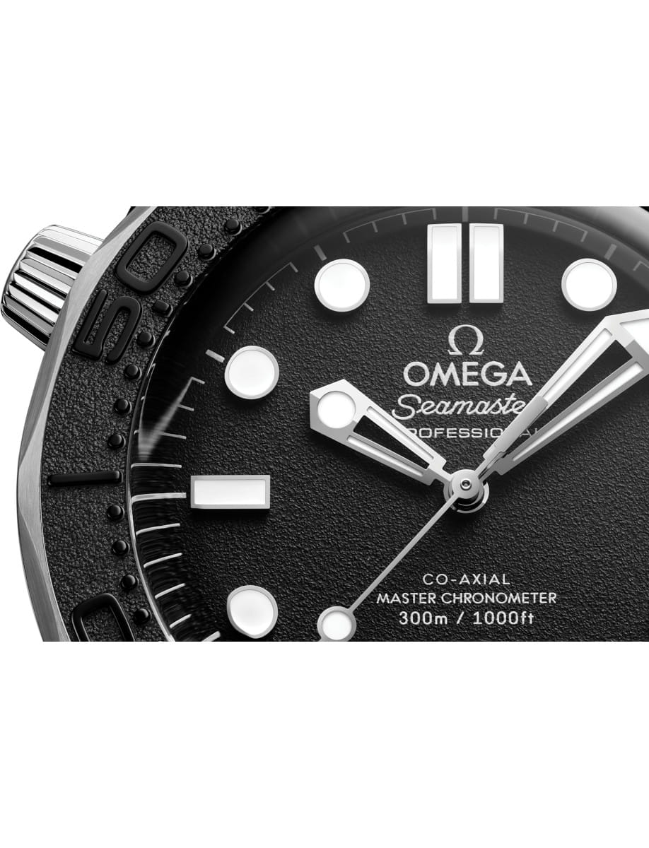 Close-up of an Omega Seamaster Professional watch dial with luminous markers and rhodium-plated hands.