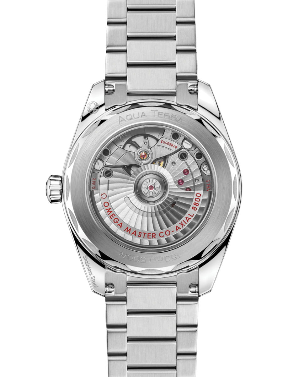Stainless steel Omega wristwatch shown from the back, exposing the intricate mechanical movement through a transparent case back.