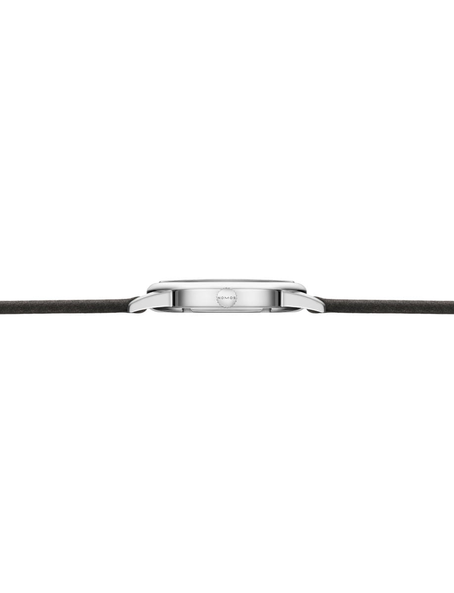 Side view of a stainless steel wristwatch with a black leather strap, showing the slim profile and crown on the side.