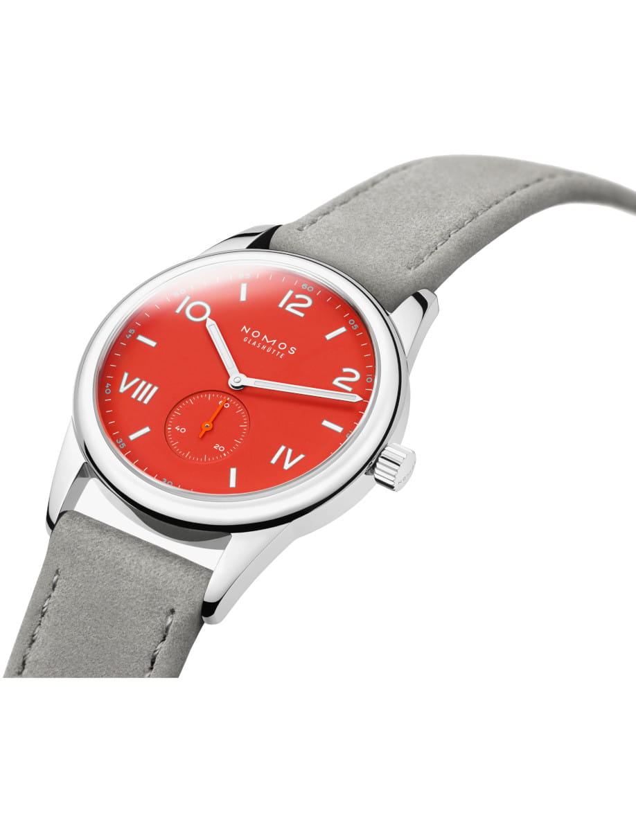 Wristwatch with a red dial, white hour markers, and a light gray strap in a steel case.